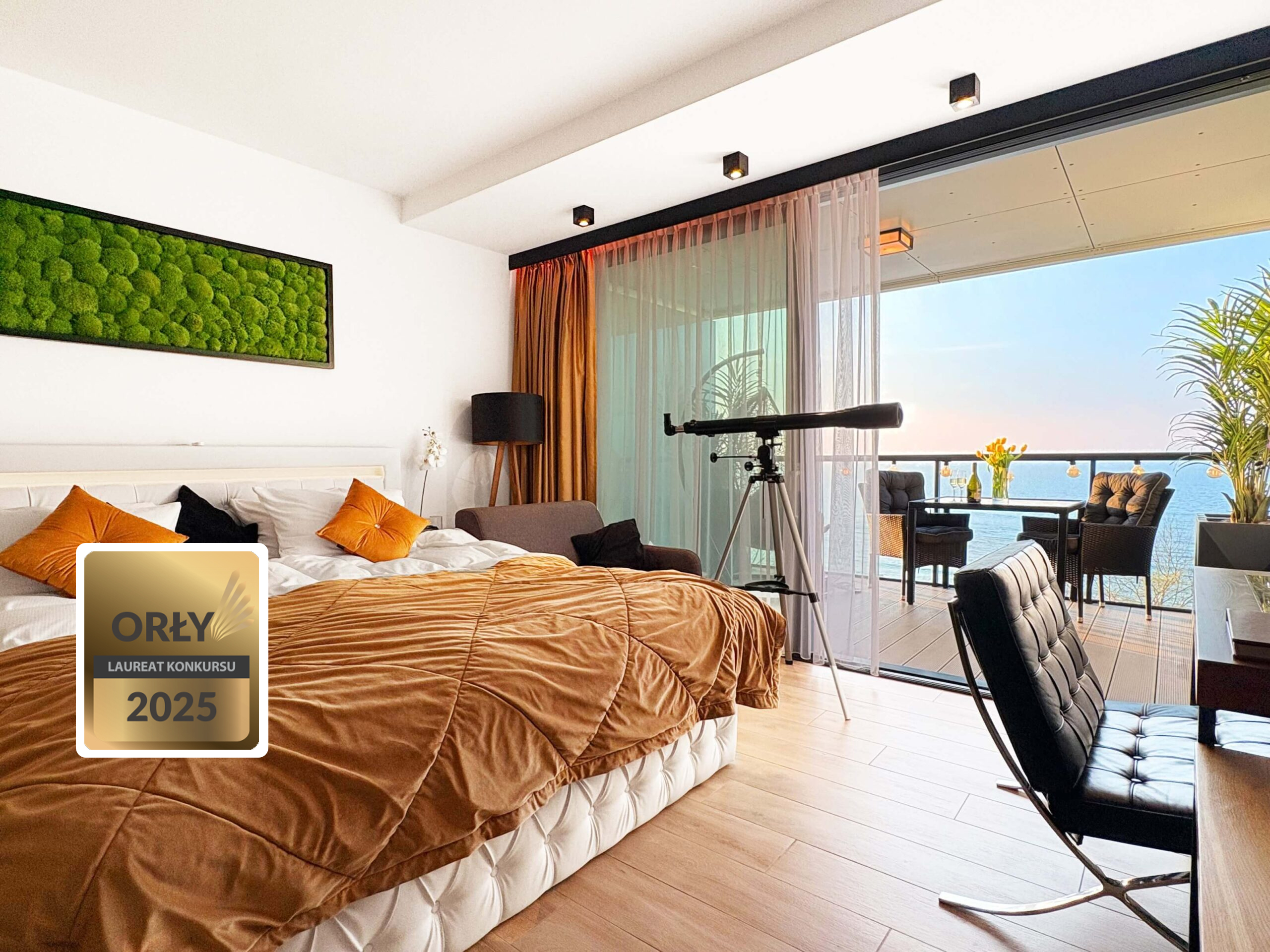 Modern bedroom with a bed, telescope, and balcony overlooking the sea
